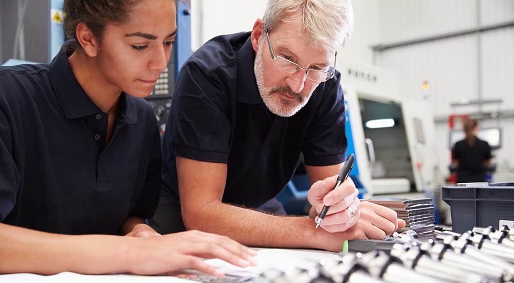 Engineer And Apprentice Planning CNC Machinery Project