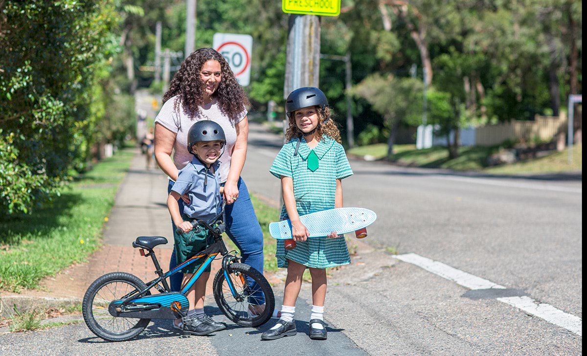 Mum and children crossing the road to school. 