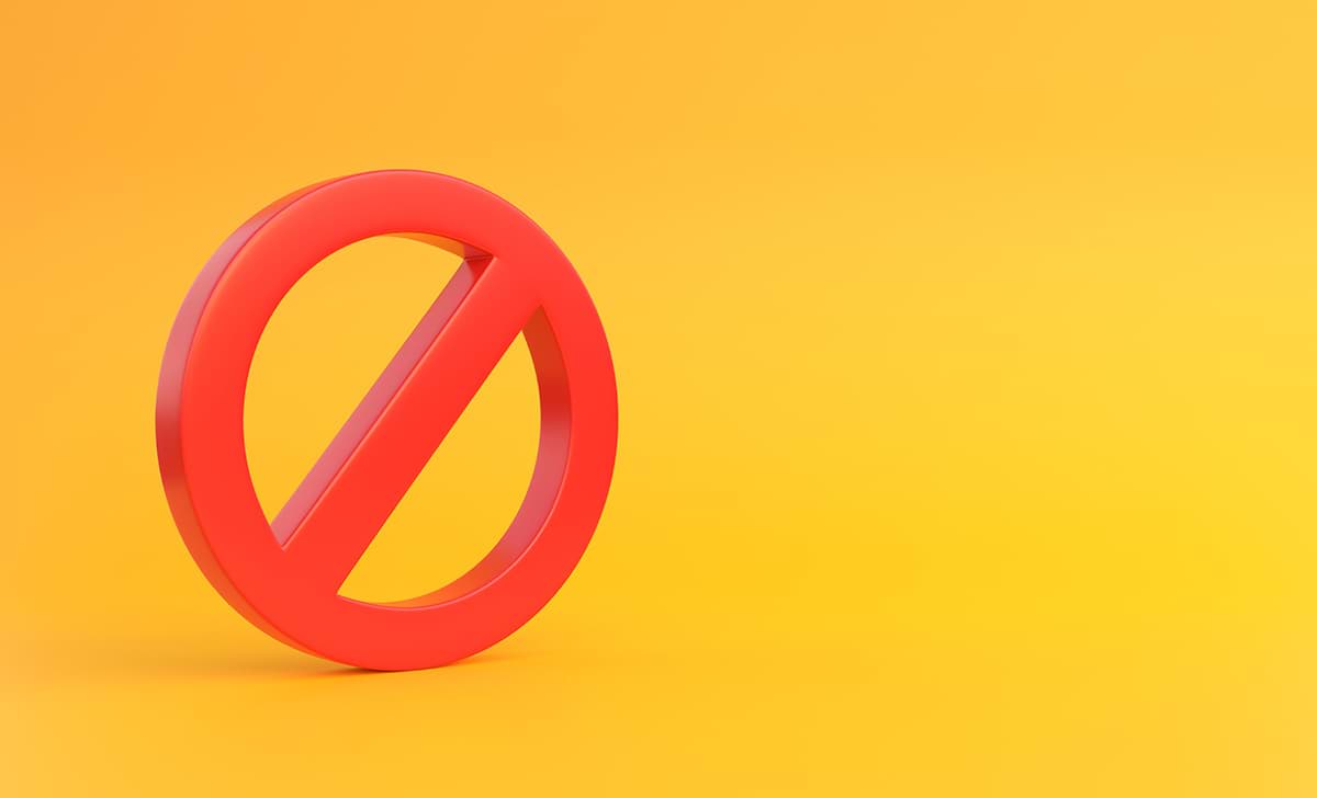 Red banned sign on a yellow background