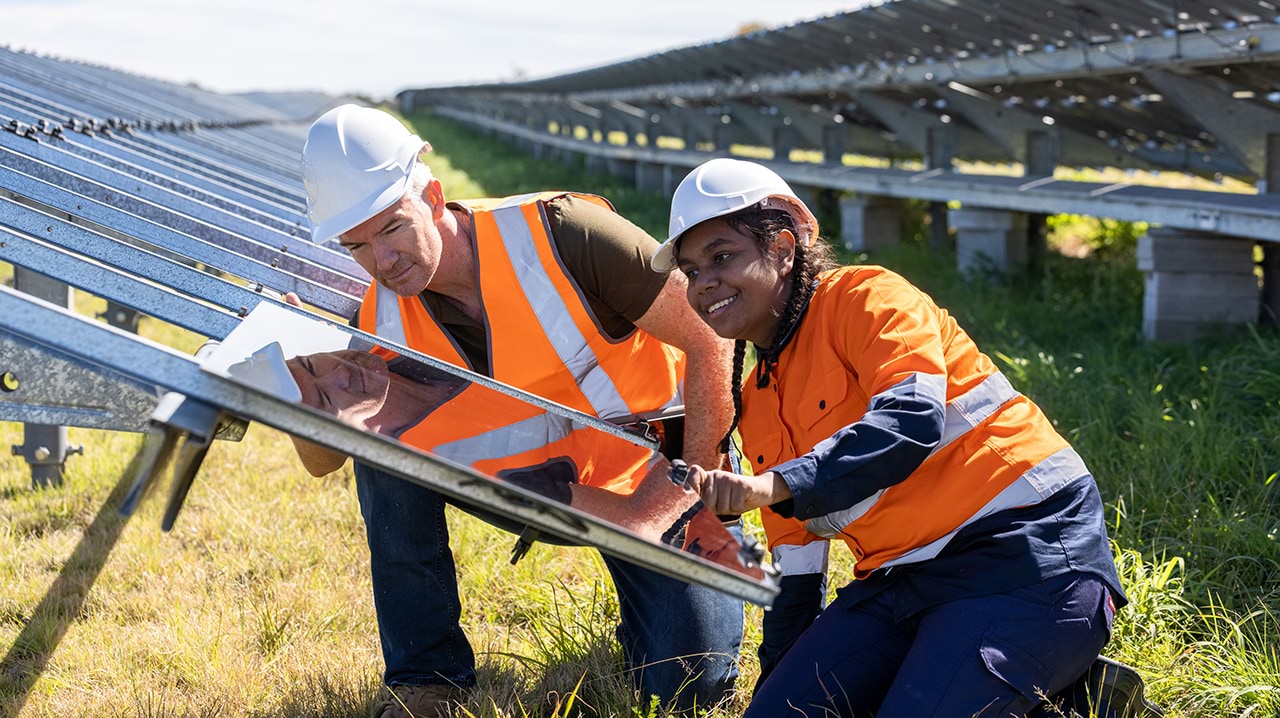 Trainees and supervisor with solar panels