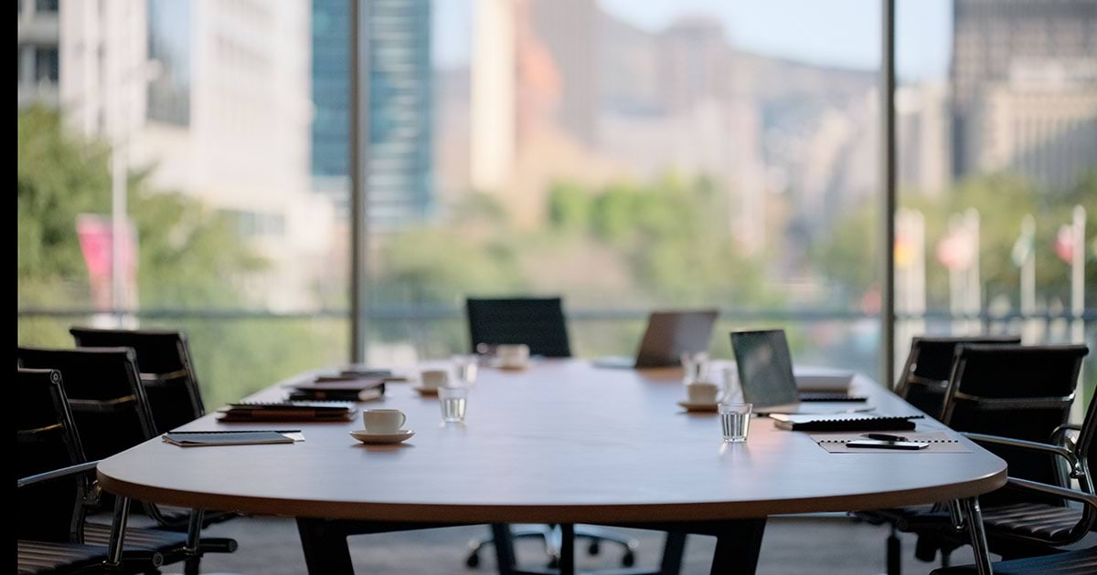 Chairs, table and technology in empty boardroom of corporate office for meeting with window view. 